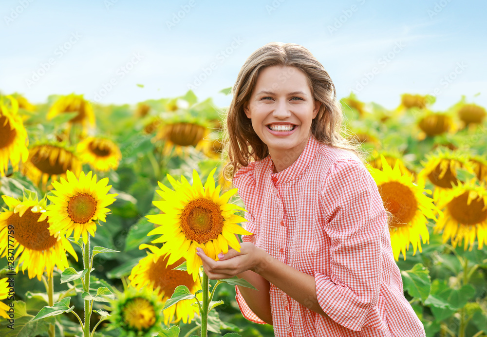 夏日向日葵地里美丽的年轻女子