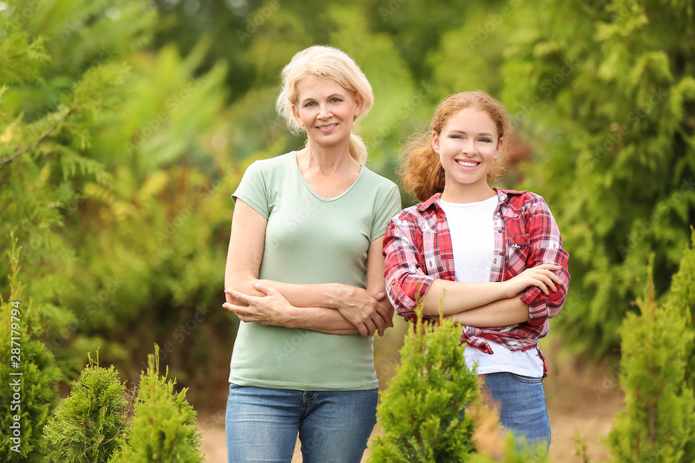 Female gardeners taking care of plants outdoors