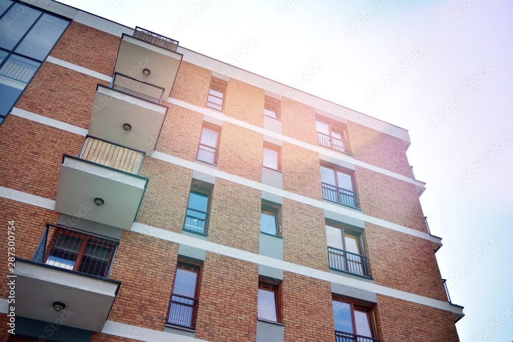 Modern apartment buildings on a sunny day with a blue sky. Facade of a modern apartment building.Gla