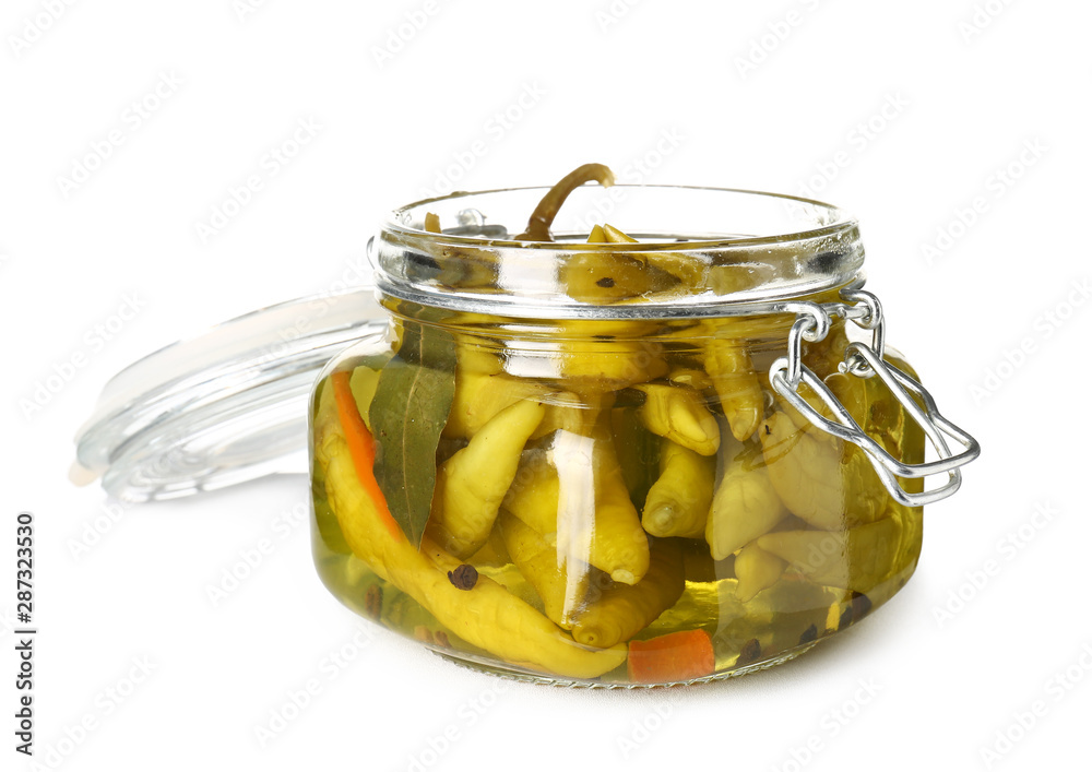 Jar with canned chili pepper on white background