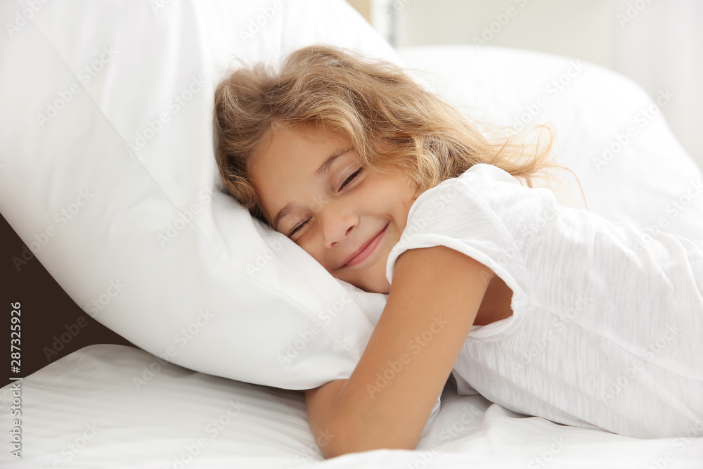 Cute little girl sleeping in bed