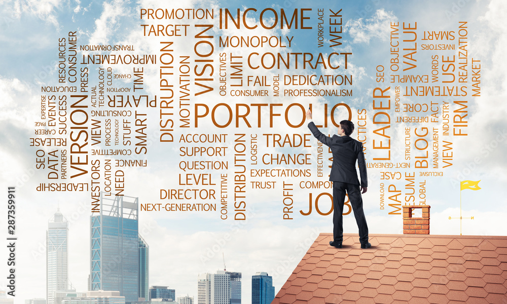 Young businessman standing on house roof and writing leadership