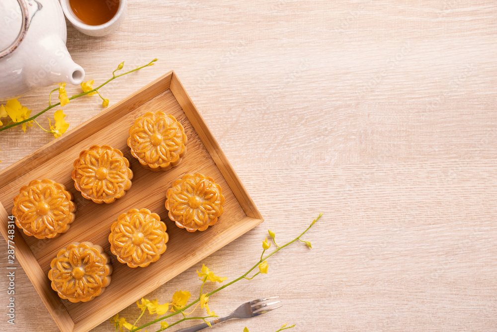 Mid-Autumn Festival holiday concept design of moon cake, mooncakes, tea set on bright wooden table w