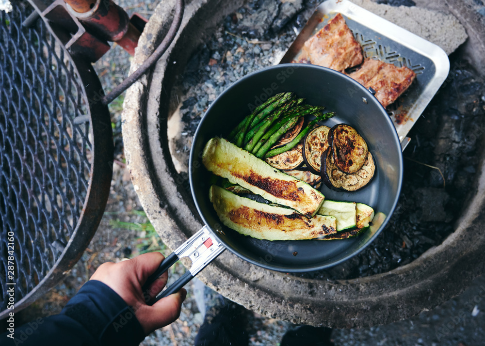 Camping zelten essen grillen über Lagerfeuer mit einem Grill 