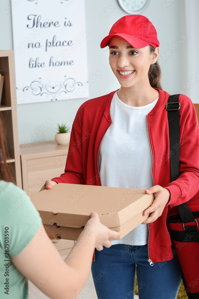 Woman receiving order from courier of food delivery company