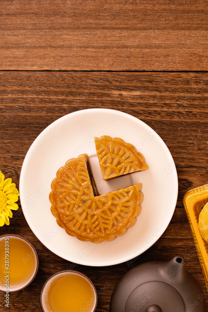 Mid-Autumn Festival holiday concept design of moon cake, mooncakes, tea set on dark wooden table wit