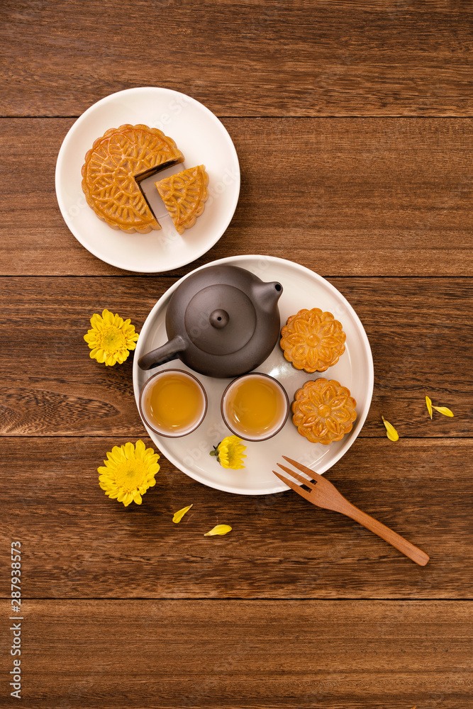 Mid-Autumn Festival holiday concept design of moon cake, mooncakes, tea set on dark wooden table wit