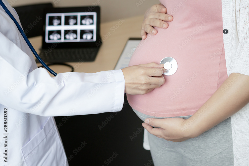 Happy pregnant woman visit gynecologist doctor at hospital or medical clinic for pregnancy consultan