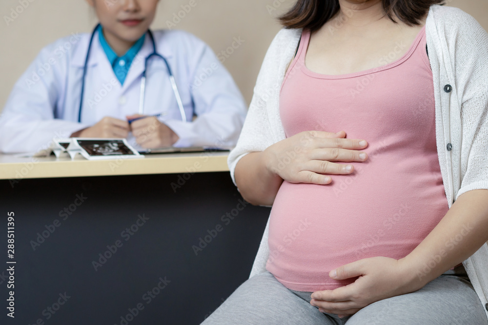 Happy pregnant woman visit gynecologist doctor at hospital or medical clinic for pregnancy consultan