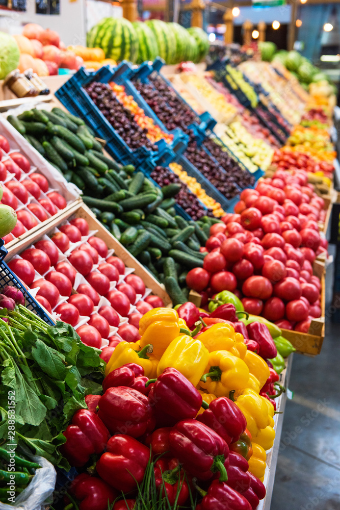 Vegetable farmer market counter: colorful various fresh organic healthy vegetables at grocery store.