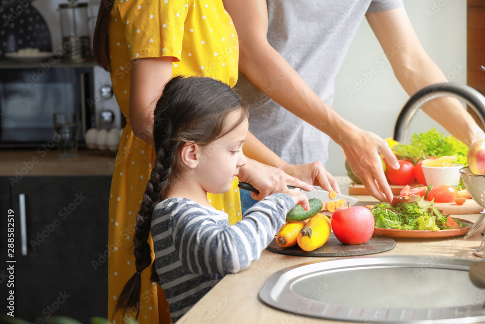 Young family cooking together in kitchen