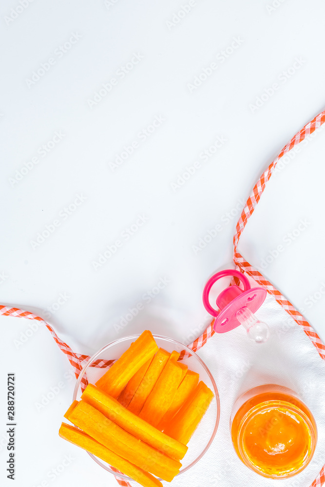 cooking mashed carrots for baby on white background top view