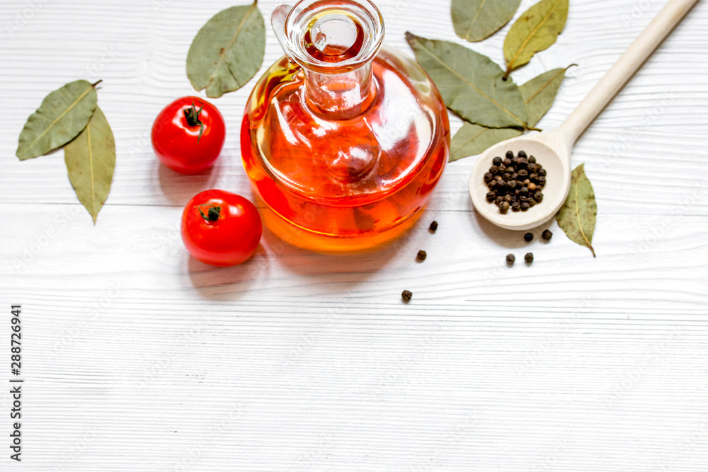 olive oil in jar on wooden background with spices