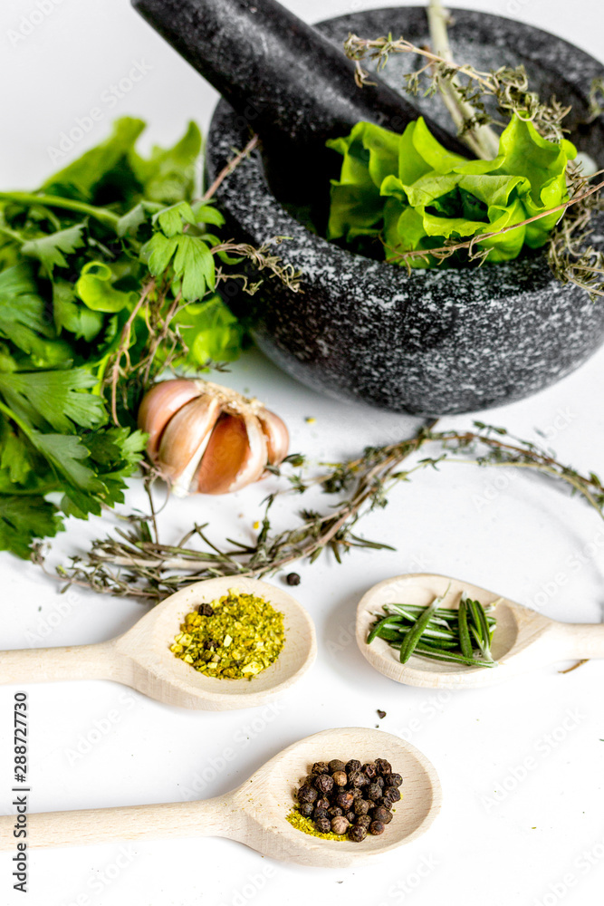 spices for cooking with pounder on white background close up