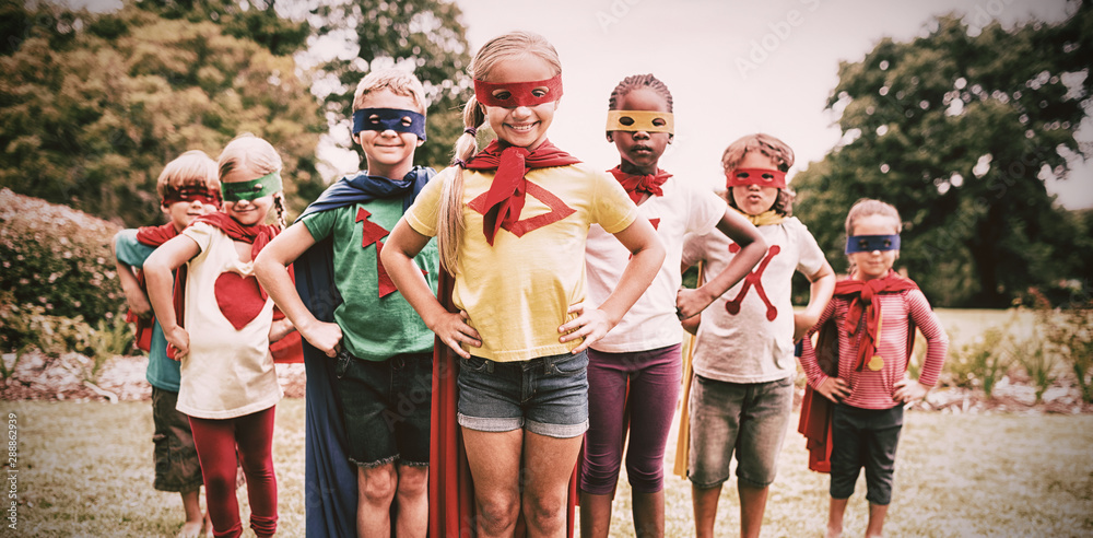 Children wearing superhero costume standing