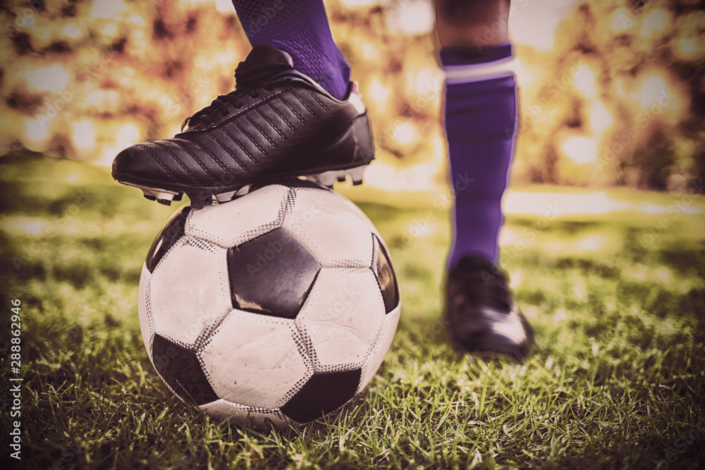 Close up view of balloon under football boots in park