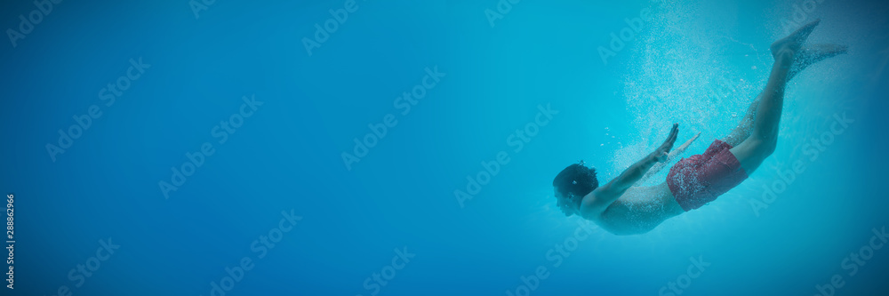 Young man swimming underwater