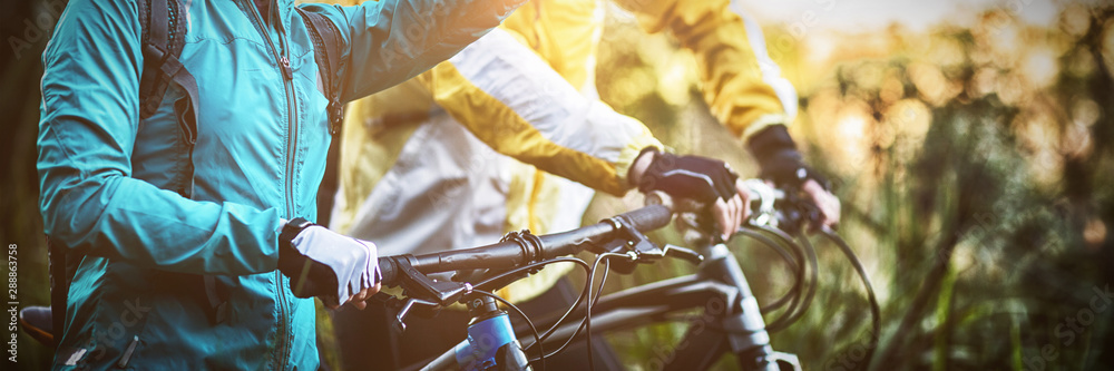 Biker couple with mountain bike pointing in distance