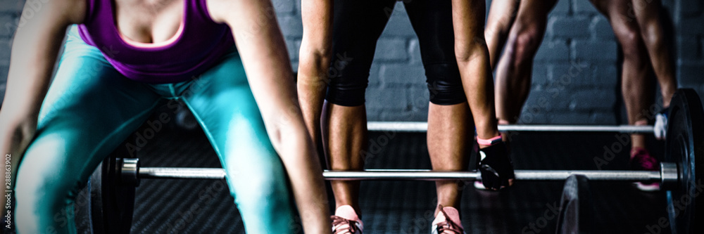 Female athletes lifting barbells