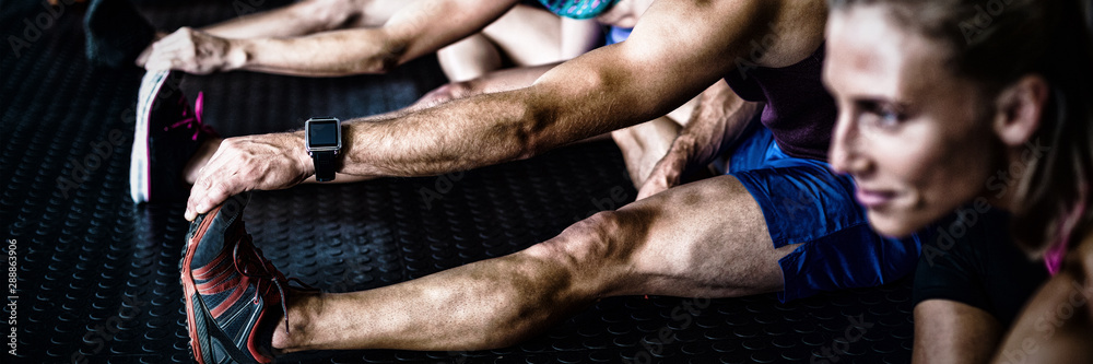 Young athlete friends stretching 