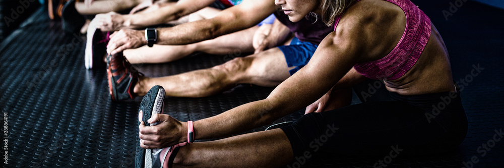 Side view of athletes stretching