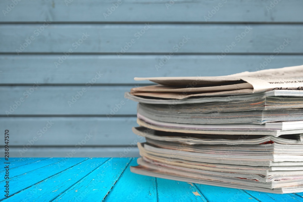 Pile of newspapers on white background