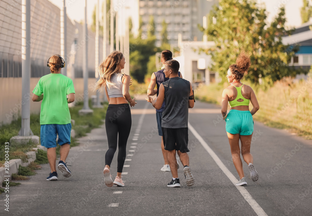 Group of sporty young people running outdoors