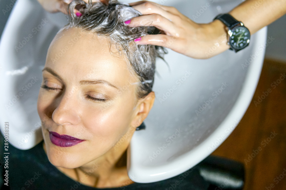 Stylist hairdresser doing haircut, process, washing hair