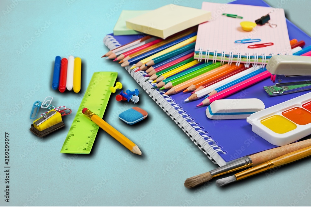 Colorful school supplies on wooden table background