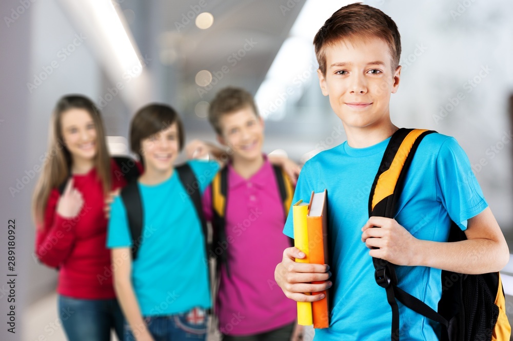 School boy with books and backpack