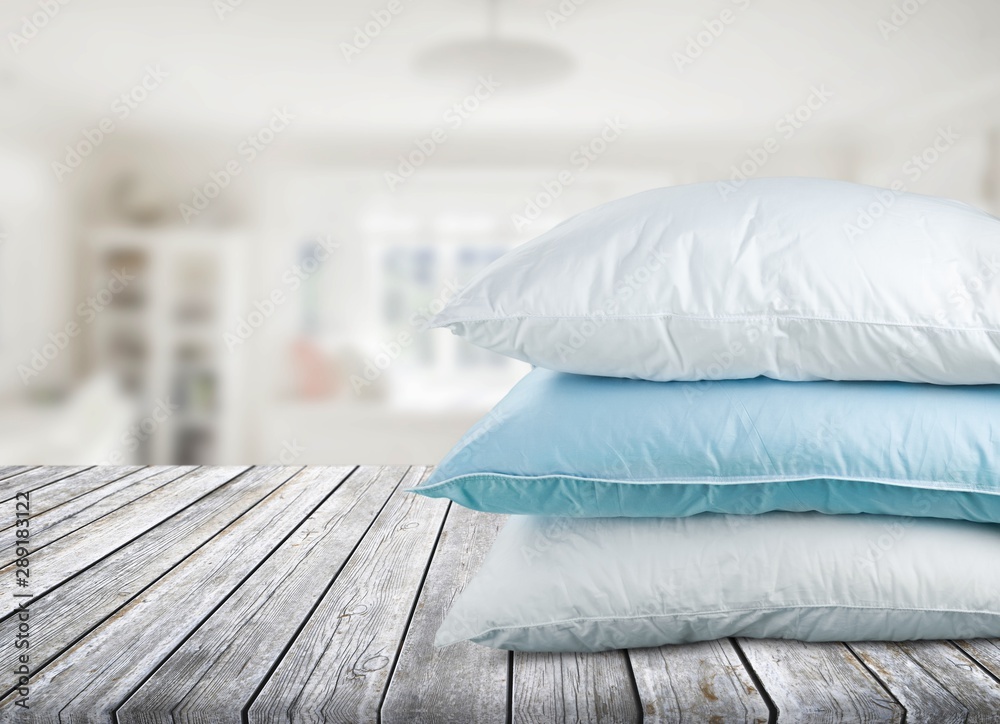 Soft Pillows Pile on grey background, three pillow, sleeping items.