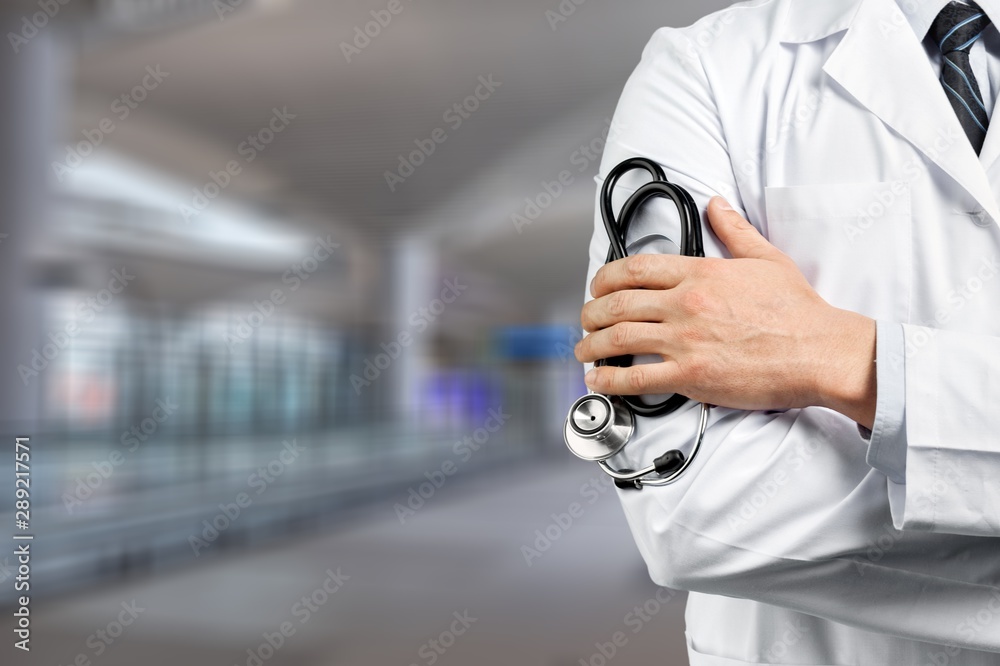 Portrait of  doctor  with arms crossed in medical office