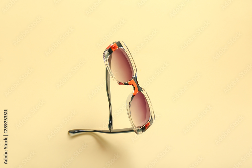 Stylish sunglasses on light background