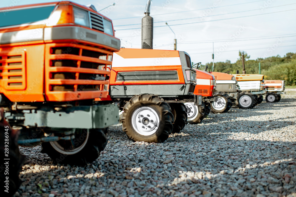 Used tractors for farming on the open ground of agricultural shop