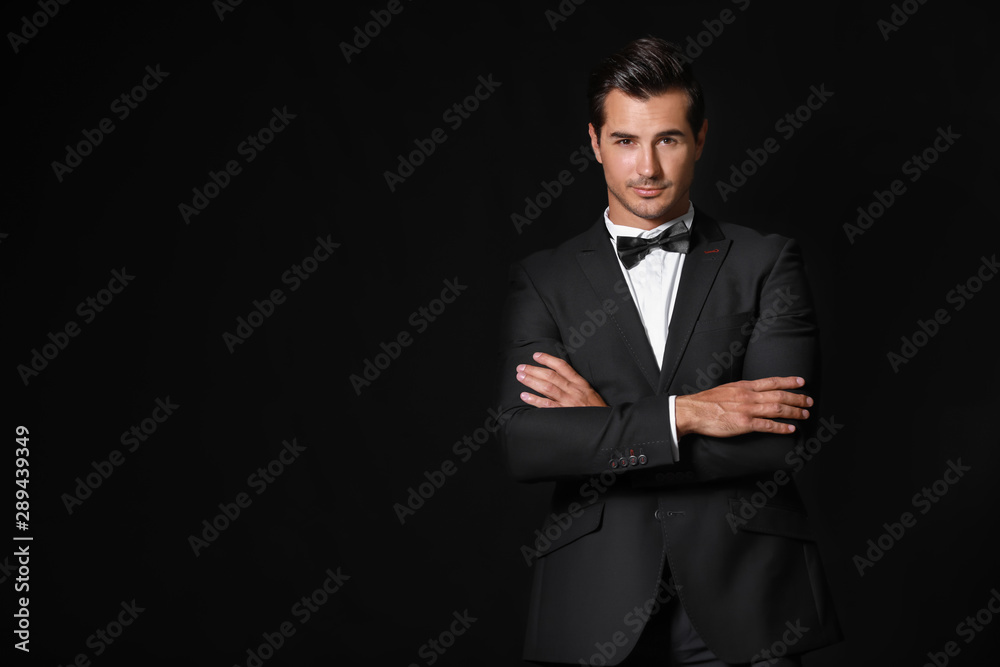 Fashionable man in formal clothes on dark background