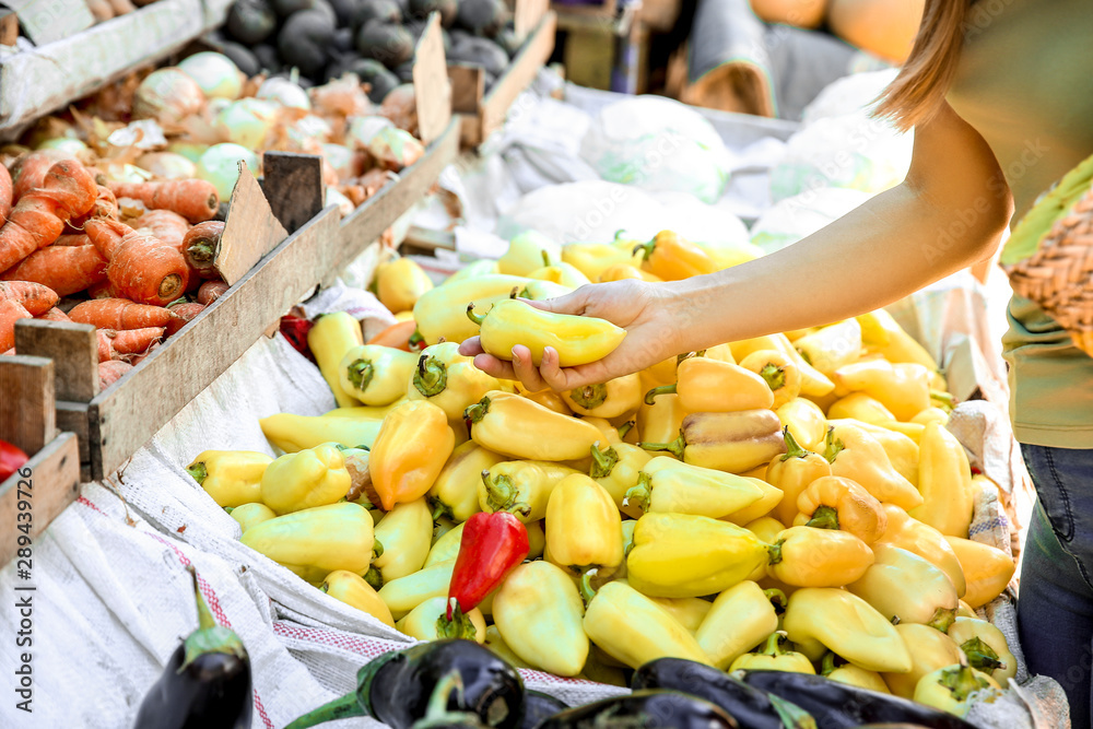 Woman choosing pepper at market