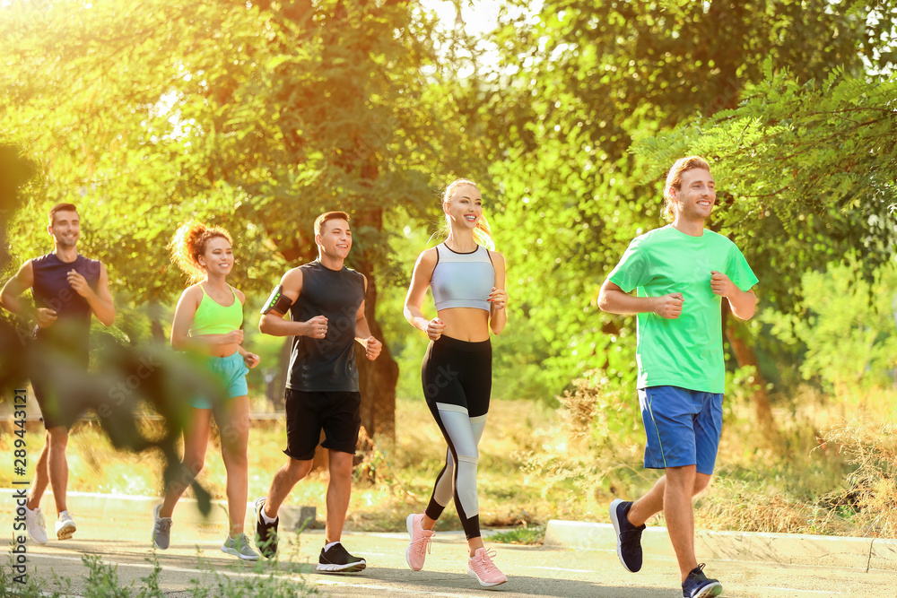 Group of sporty young people running outdoors