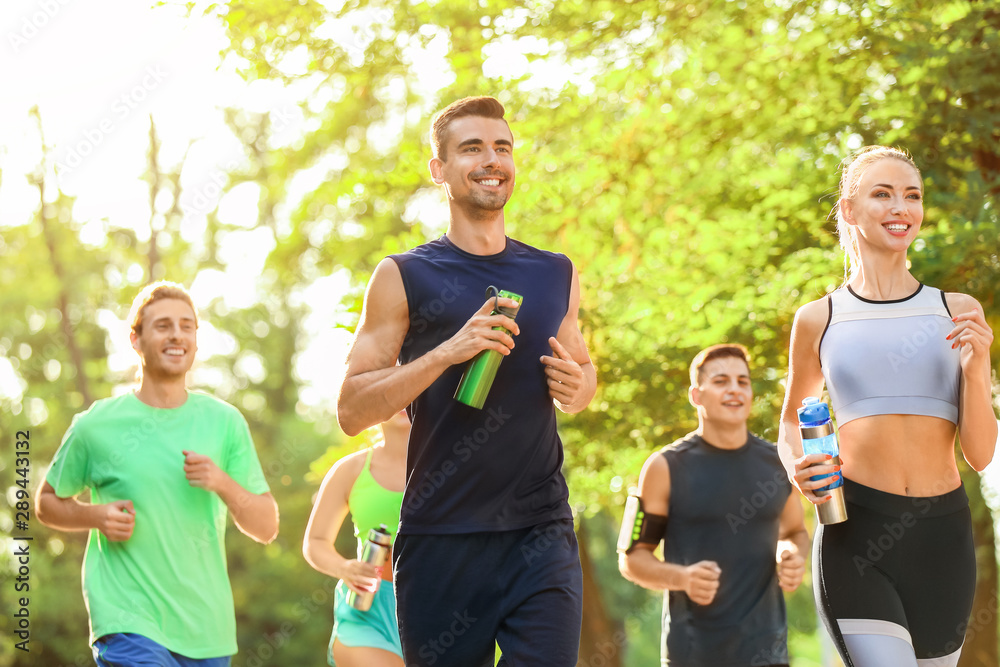 Group of sporty young people running outdoors