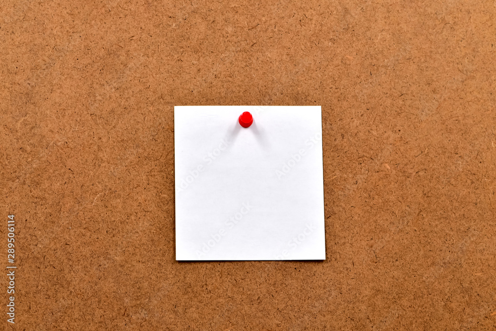 White blank sheet of paper attached to the chipboard with a push button