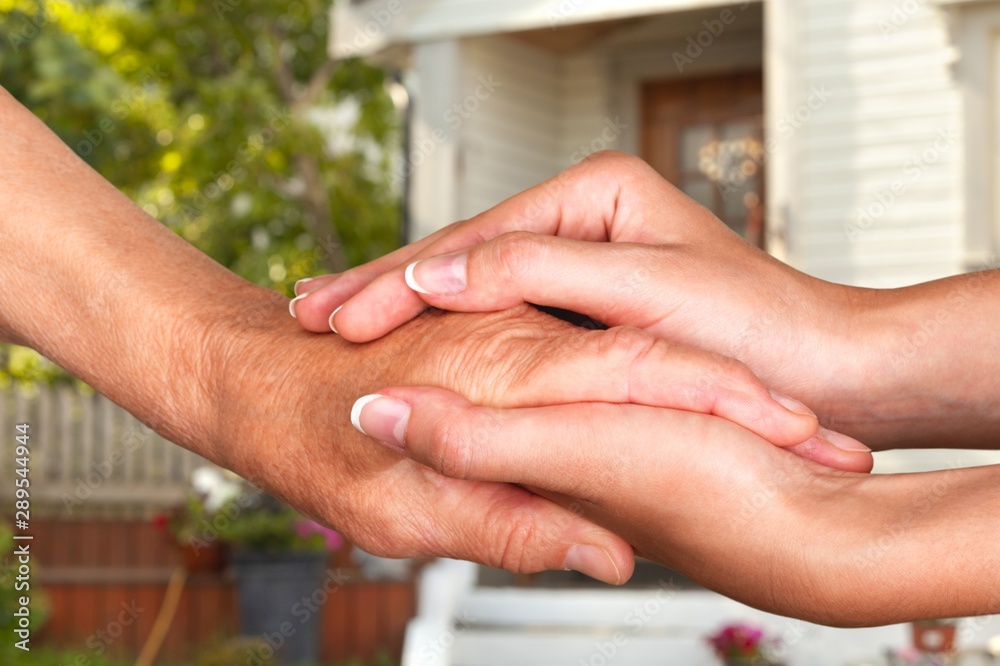 Hands of the old man and a young woman. close up.