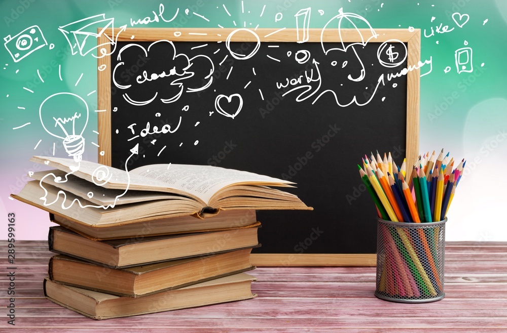 Stack of books, blackboard and pencils, education and learning background