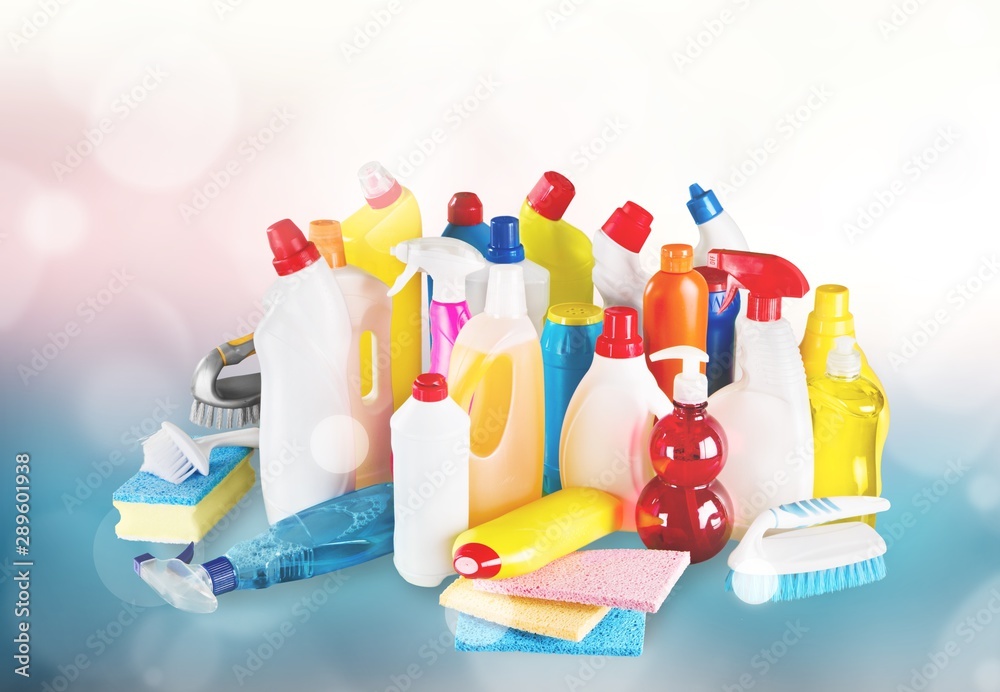 Plastic bottles, cleaning sponges and gloves on blue background