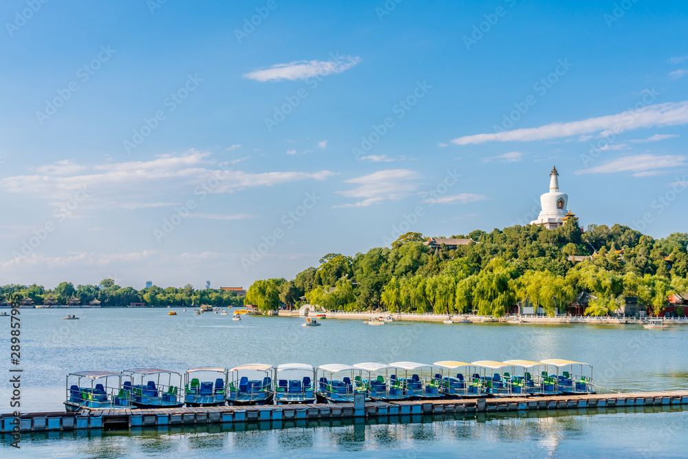 White tower and cruise ship in Beihai Park, Beijing, China