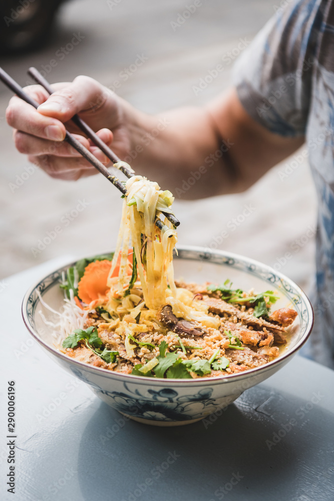 男子在越南餐厅用餐。男子在吃新鲜烹制的越南咖喱面