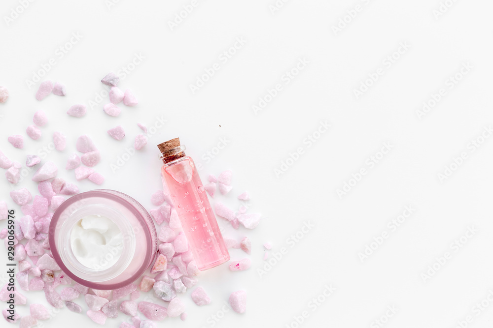 Pebble and cream with body lotion on white background top view mockup