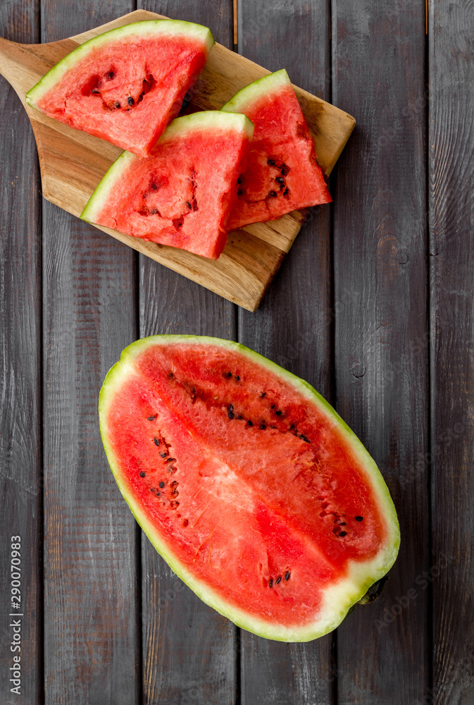 Slices of watermelon on wooden background top view