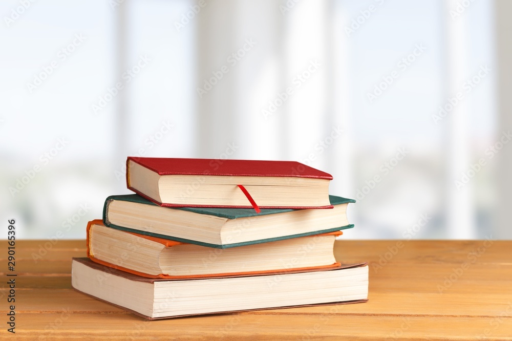 Colorful books collection on background.