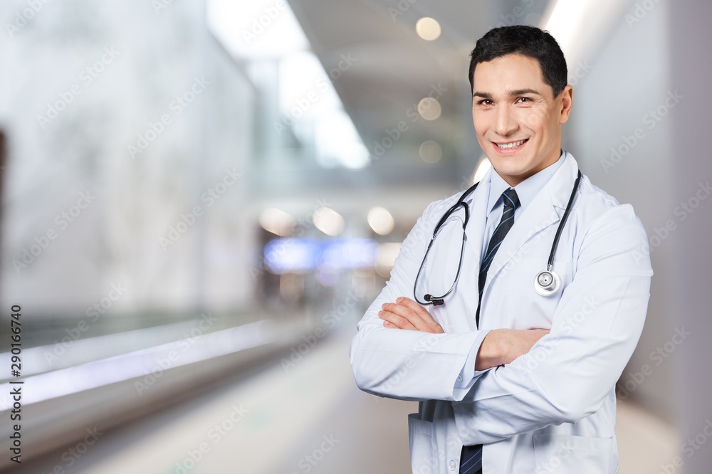 Young doctor portrait at blurred hospital background, bokeh