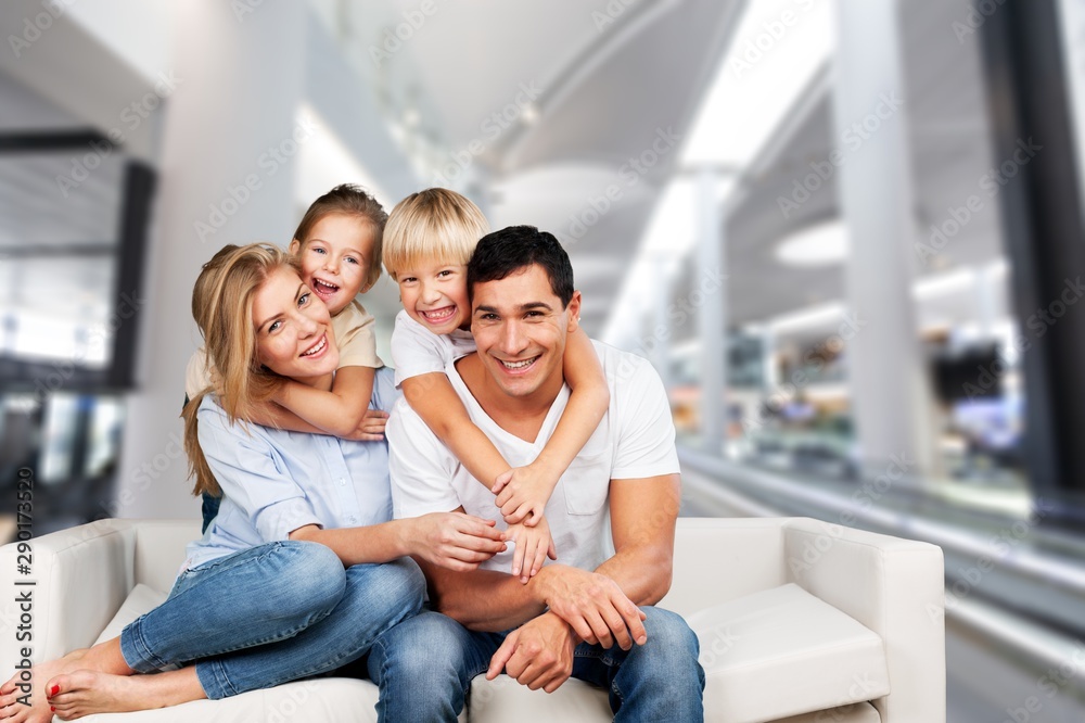 Young family at home smiling at camera