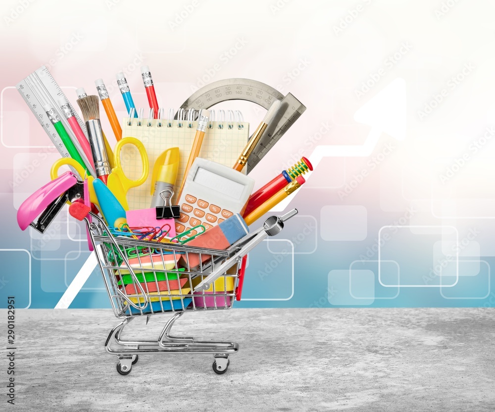 Colorful school supplies in shopping cart